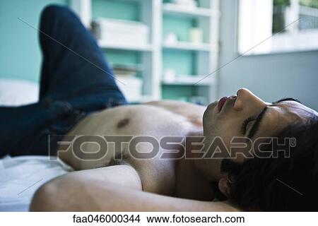Man resting in bedroom View Large Photo Image Picture - Man resting in bedroom. Fotosearch