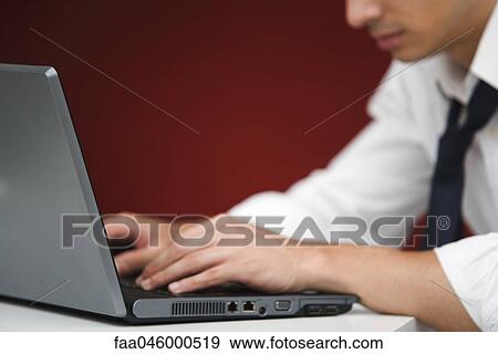 Stock Photo - Man using laptop computer. Fotosearch