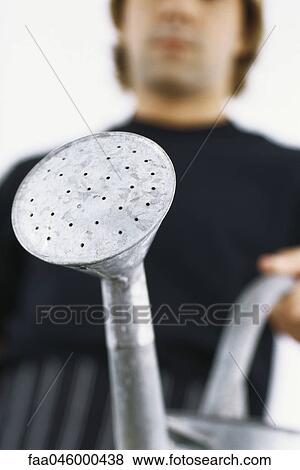 Man with watering can, cropped View Large Photo Image Stock Photo - Man with watering can, cropped. Fotosearch
