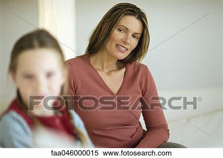 Mother looking at daughter with pride View Large Photo Image Stock Photography - Mother looking at daughter with pride. Fotosearch