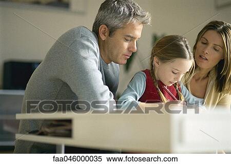 Parents helping young daughter with homework View Large Photo Image Stock Photography - Parents helping young daughter with homework. Fotosearch