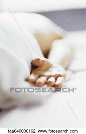Stock Image - Person lying on stomach on massage table, cropped. Fotosearch
