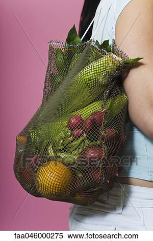Stock Photography - Sack of fresh vegetables carried over shoulder. Fotosearch
