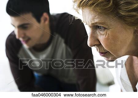 Senior woman looking intently, man in background View Large Photo Image Picture - Senior woman looking intently, man in background. Fotosearch