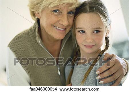 Senior woman with arm around granddaughter, portrait View Large Photo Image Picture - Senior woman with arm around granddaughter, portrait. Fotosearch