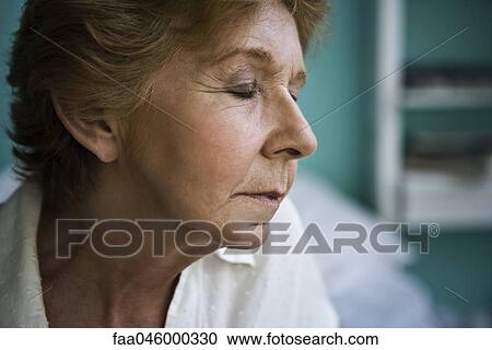 Stock Image - Senior woman with eyes closed. Fotosearch