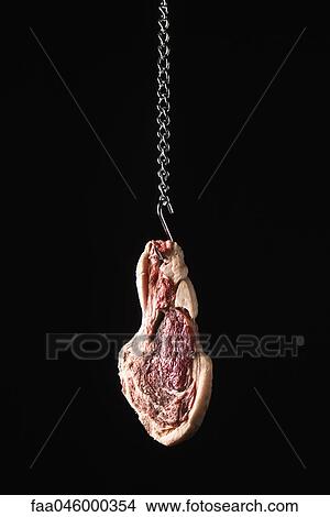 Picture - Steak hanging from meat hook. Fotosearch