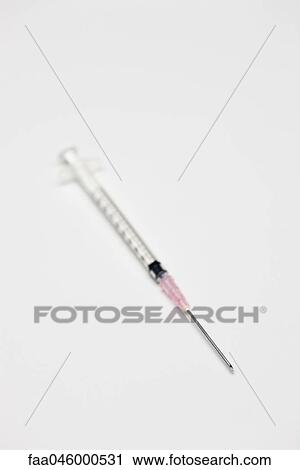 Stock Image - Syringe containing medication. Fotosearch