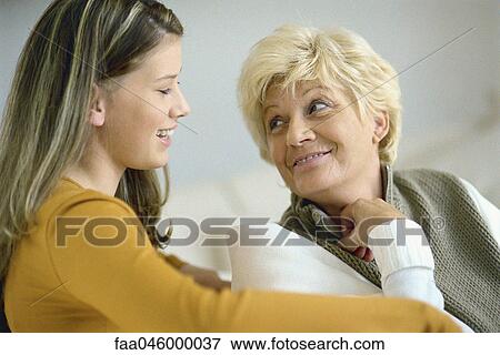 Teenage girl talking with grandmother View Large Photo Image Stock Photo - Teenage girl talking with grandmother. Fotosearch