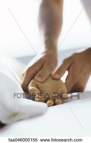 Therapist massaging patient's hand, cropped View Large Photo Image Stock Photography - Therapist massaging patient's hand, cropped. Fotosearch