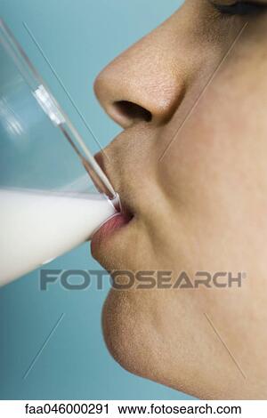 Woman drinking glass of milk, close-up View Large Photo Image Stock Image - Woman drinking glass of milk, close-up. Fotosearch