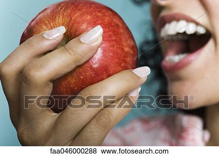 Woman eating apple, close-up View Large Photo Image Stock Photo - Woman eating apple, close-up. Fotosearch