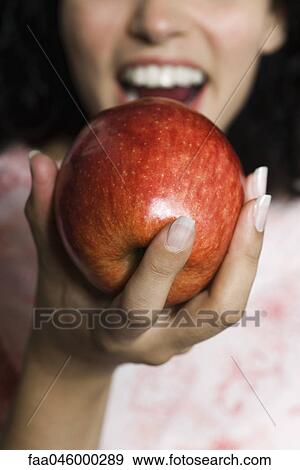 Woman eating apple, cropped View Large Photo Image Stock Photo - Woman eating apple, cropped. Fotosearch
