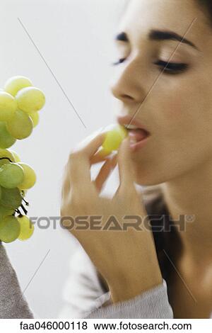 Woman eating grapes View Large Photo Image Stock Photo - Woman eating grapes. Fotosearch