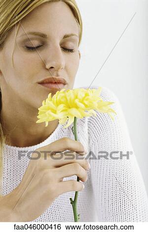 Woman enjoying flower's fragrance View Large Photo Image Stock Photograph - Woman enjoying flower's fragrance. Fotosearch