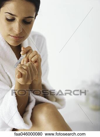 Woman filing her nails View Large Photo Image Stock Image - Woman filing her nails. Fotosearch