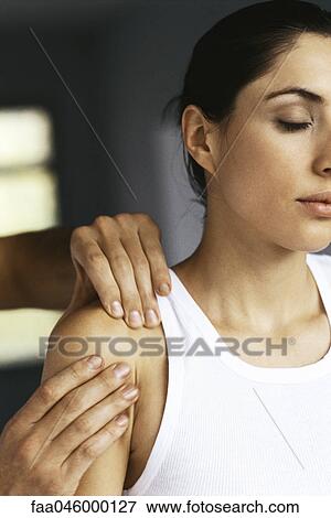 Woman having shoulder massaged View Large Photo Image Stock Photo - Woman having shoulder massaged. Fotosearch