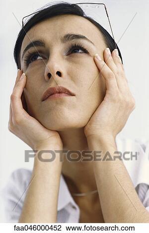 Woman holding head, looking up View Large Photo Image Stock Image - Woman holding head, looking up. Fotosearch