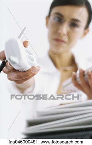 Woman holding out cordless phone, personal perspective View Large Photo Image Stock Image - Woman holding out cordless phone, personal perspective. Fotosearch