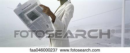 Woman in business attire reading newspaper on beach, cropped View Large Photo Image Stock Photo - Woman in business attire reading newspaper on beach, cropped. Fotosearch