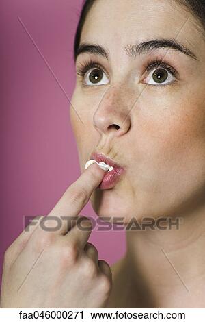 Woman licking ice cream from finger View Large Photo Image Stock Image - Woman licking ice cream from finger. Fotosearch