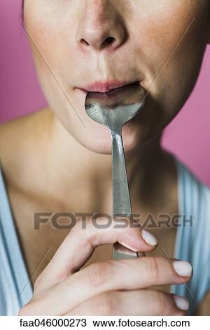 Woman licking spoon, cropped View Large Photo Image Stock Image - Woman licking spoon, cropped. Fotosearch