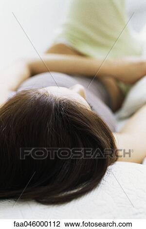 Woman lying on back relaxing View Large Photo Image Stock Image - Woman lying on back relaxing. Fotosearch