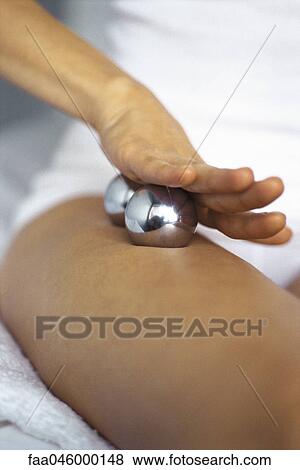 Woman massaging leg with yin yang balls, cropped View Large Photo Image Stock Photo - Woman massaging leg with yin yang balls, cropped. Fotosearch
