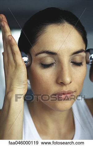 Woman massaging temples with yin yang balls View Large Photo Image Stock Photo - Woman massaging temples with yin yang balls. Fotosearch
