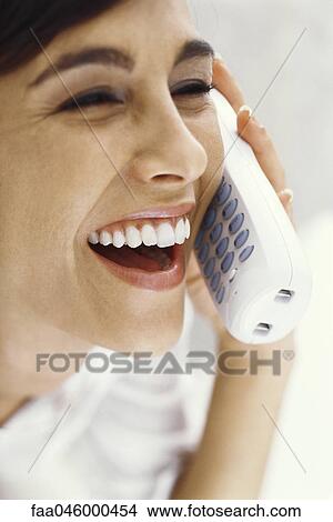Picture - Woman on phone call, smiling and laughing. Fotosearch