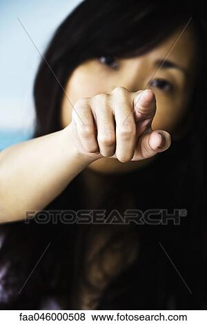 Stock Photo - Woman pointing confrontationally at camera. Fotosearch