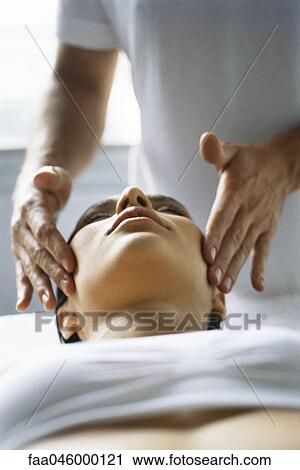 Woman receiving head massage View Large Photo Image Stock Image - Woman receiving head massage. Fotosearch