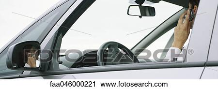 Woman sitting in car using cell phone View Large Photo Image Stock Image - Woman sitting in car using cell phone. Fotosearch