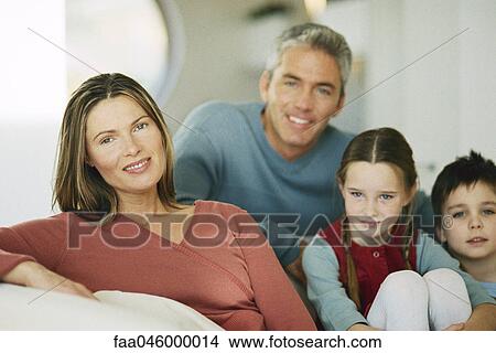 Woman sitting with husband and two children, portrait View Large Photo Image Picture - Woman sitting with husband and two children, portrait. Fotosearch