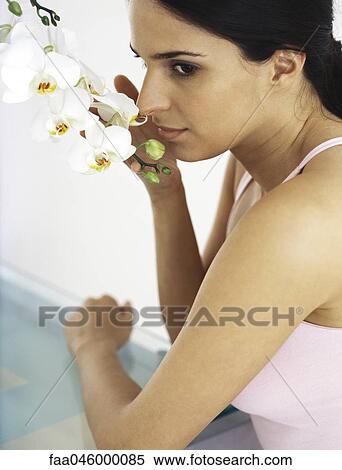 Woman smelling orchid View Large Photo Image Stock Photography - Woman smelling orchid. Fotosearch