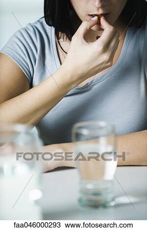 Woman taking vitamins, cropped View Large Photo Image Stock Image - Woman taking vitamins, cropped. Fotosearch