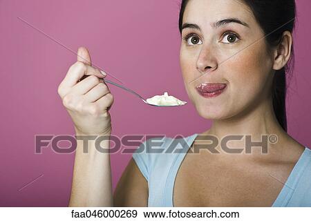 Woman tasting spoon full of ice cream, licking lips View Large Photo Image Stock Photo - Woman tasting spoon full of ice cream, licking lips. Fotosearch