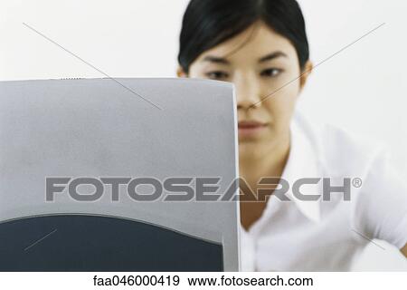 Stock Photo - Woman using laptop computer. Fotosearch