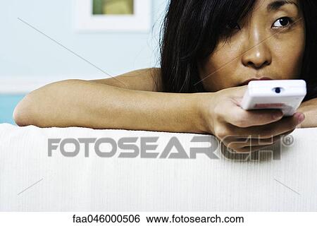Woman using remote control View Large Photo Image Stock Photograph - Woman using remote control. Fotosearch