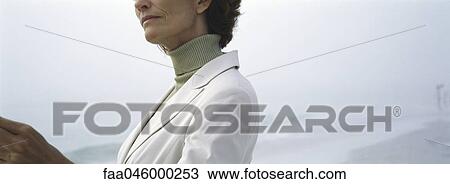 Stock Image - Woman wearing turtleneck and jacket, cropped. Fotosearch