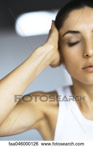 Woman with eyes closed holding head View Large Photo Image Stock Photograph - Woman with eyes closed holding head. Fotosearch