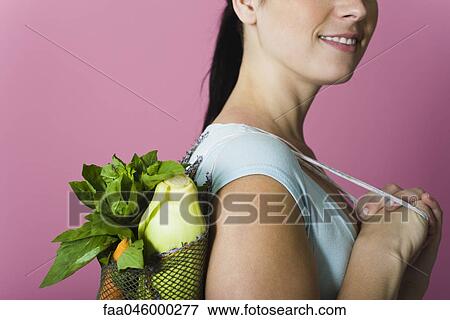 Woman with sack of fresh vegetables carried over shoulder View Large Photo Image Stock Photo - Woman with sack of fresh vegetables carried over shoulder. Fotosearch