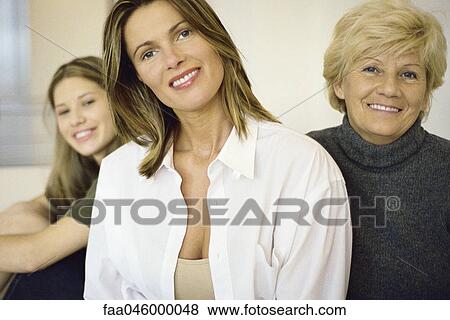 Woman with senior mother, teenage daughter in background View Large Photo Image Stock Photo - Woman with senior mother, teenage daughter in background. Fotosearch