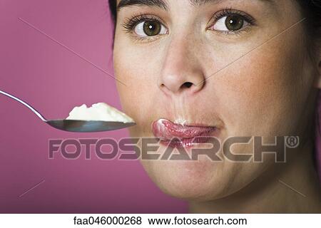 Woman with spoon full of ice cream, licking lips View Large Photo Image Stock Photo - Woman with spoon full of ice cream, licking lips. Fotosearch