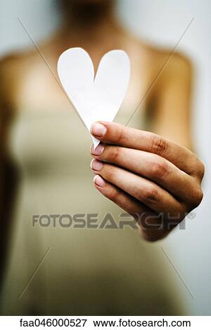 Stock Photo - Woman's hand holding out paper heart. Fotosearch