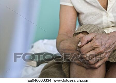 Woman's hands clasped on knee, close-up View Large Photo Image Picture - Woman's hands clasped on knee, close-up. Fotosearch