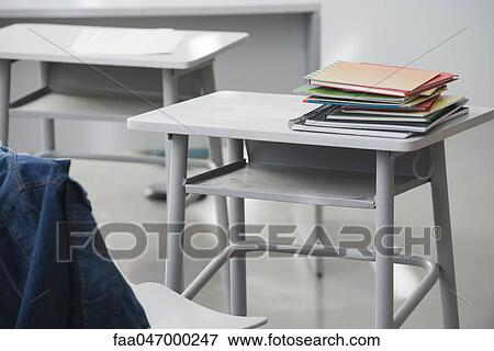 Stock Photo - Books stacked on school desk. Fotosearch