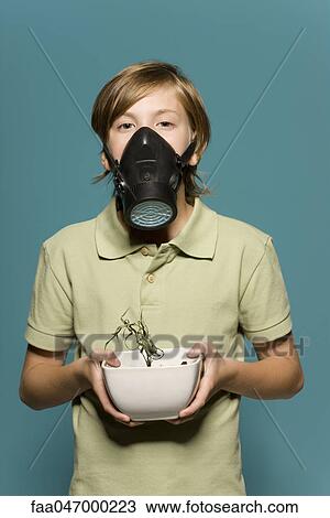 Boy wearing gas mask, holding wilted potted plant View Large Photo Image Stock Image - Boy wearing gas mask, holding wilted potted plant. Fotosearch