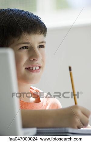 Boy writing in notebook View Large Photo Image Picture - Boy writing in notebook. Fotosearch