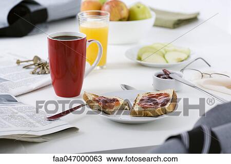 Stock Image - Breakfast and newspaper on table. Fotosearch